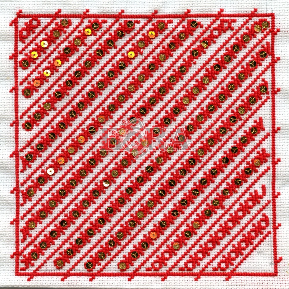 Patch 74: diagonal red cross-stitch bands with gold sequins on white cloth